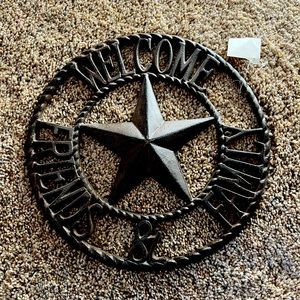 Cast iron welcome sign. “WELCOME FRIENDS & FAMILY”